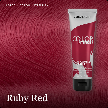 A tube of Vero K-Pak Color Intensity semi-permanent hair dye in Ruby Red, shown against a background of deep, saturated hair color swatches. The text 'JOICO - COLOR INTENSITY'