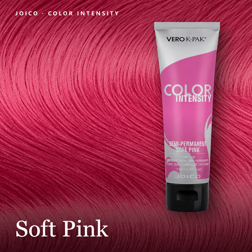 A tube of Vero K-Pak Color Intensity semi-permanent hair dye in Soft Pink, shown against a background of vibrant pink hair swatches. The text 'Soft Pink' is displayed at the bottom left, 