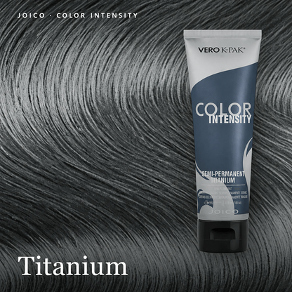 A tube of Vero K-Pak Color Intensity semi-permanent hair dye in the shade Titanium, shown against a background of dark gray to black hair swatches. The text 'Titanium' is displayed at the bottom left.